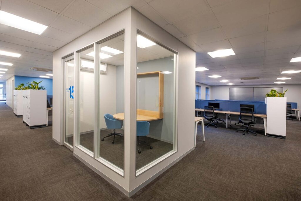 anlam Houghton large office with acoustic booths, storage, desks, chairs and partitions, showcasing flexible workplace furniture solutions