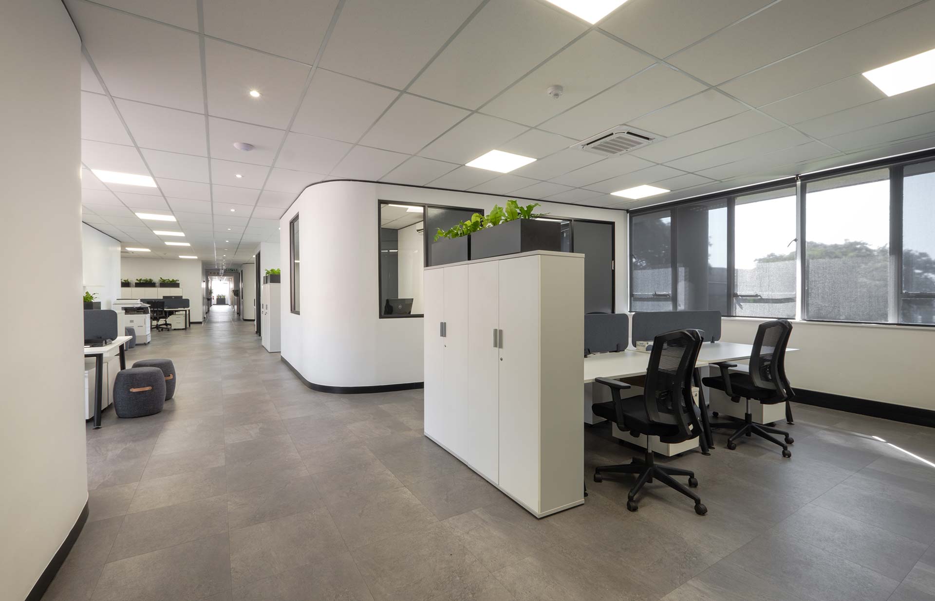 Snowsoft open-plan office with shared timber desks, ergonomic chairs and timber slatted partitioning, showcasing modern workspace planning and furniture solutions