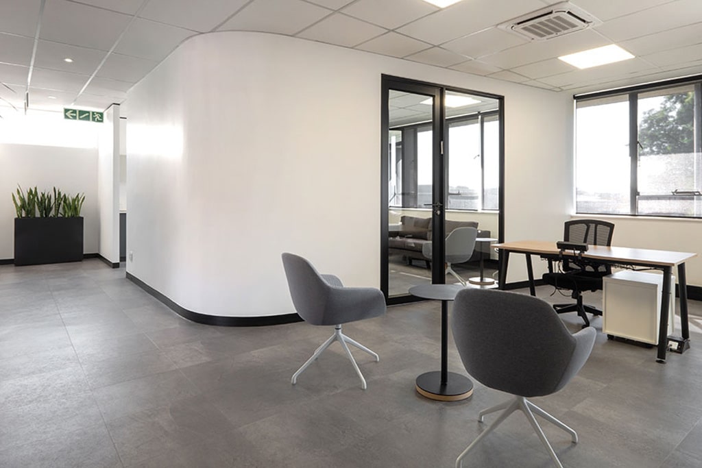 Snowsoft corporate workspace with timber desks, wooden chairs and integrated planters, featuring contemporary corporate furniture and workplace furnishings