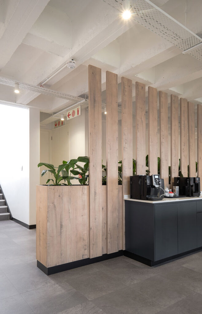 Snowsoft open-plan office with shared timber desks, ergonomic chairs and timber slatted partitioning, showcasing modern workspace planning and furniture solutions
