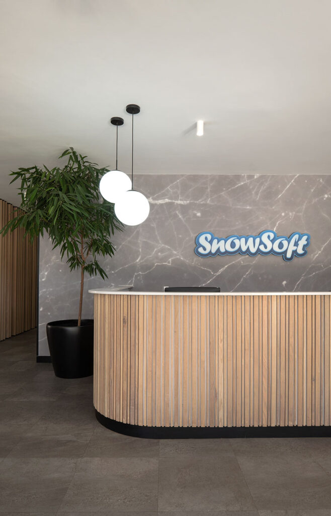 Snowsoft modern reception area with a high-quality timber reception desk, marble countertop and integrated planters, showcasing premium office furniture design
