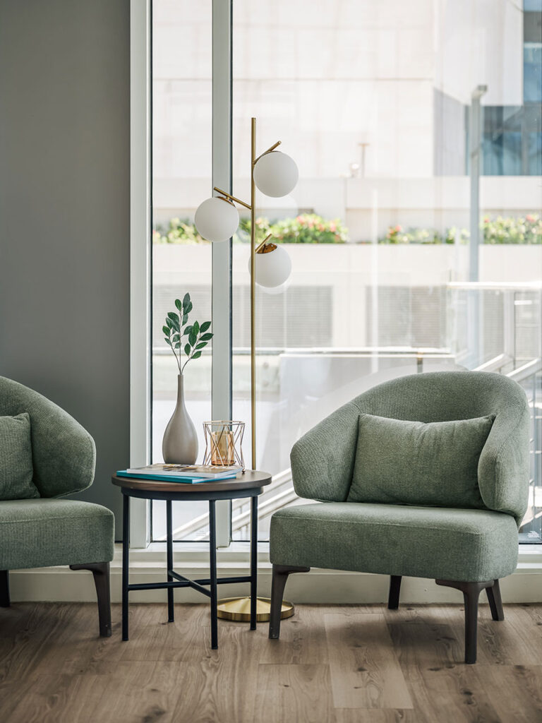 Soma Bay Cairo, Egypt interior with a premium mint green armchair, coffee table, decorative lighting and planters, showcasing curated hospitality furniture and FF&E procurement