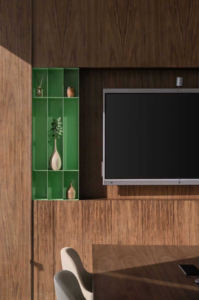 Soma Bay Cairo, Egypt high-end boardroom with bespoke furniture, custom green shelving and refined décor for an audiovisual meeting room, showcasing premium FF&E furniture sourcing