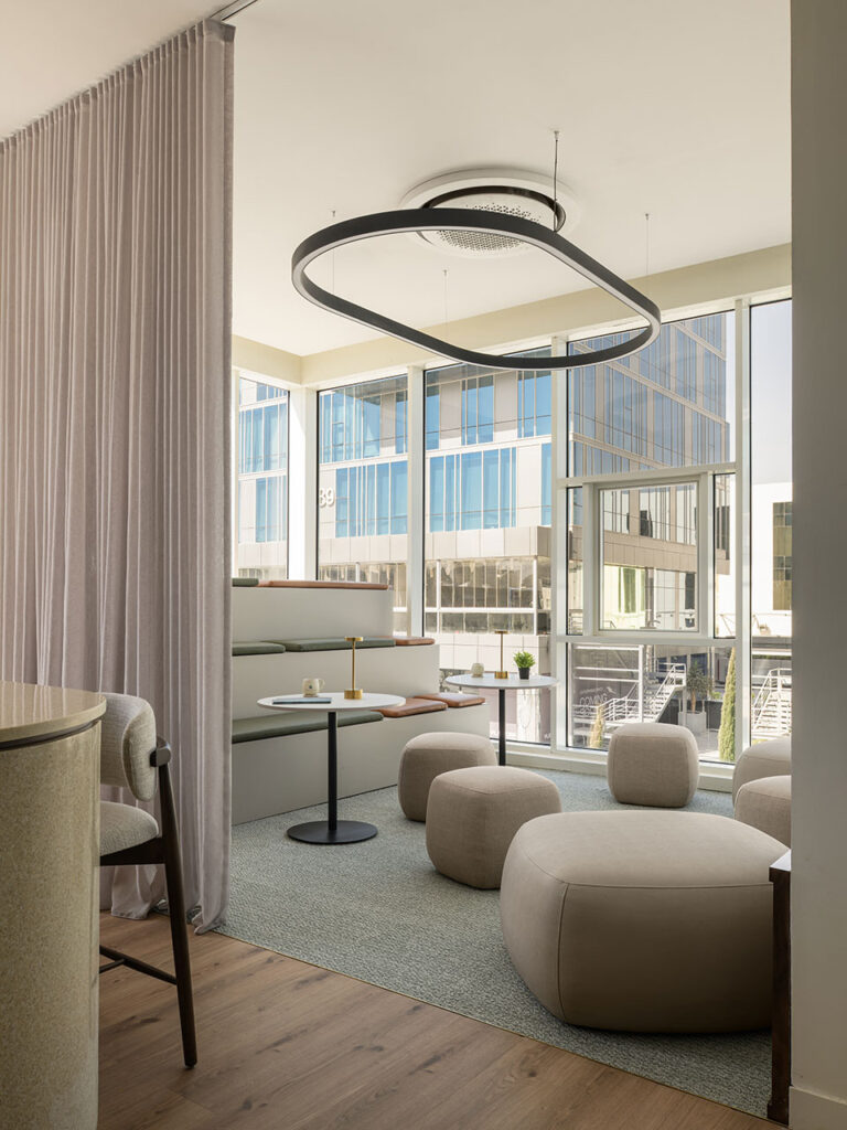 Soma Bay Cairo, Egypt corporate collaboration zone with custom multi-level benches, breakout ottomans, laptop tables and contemporary lighting, showcasing flexible workplace furniture and FF&E solutions