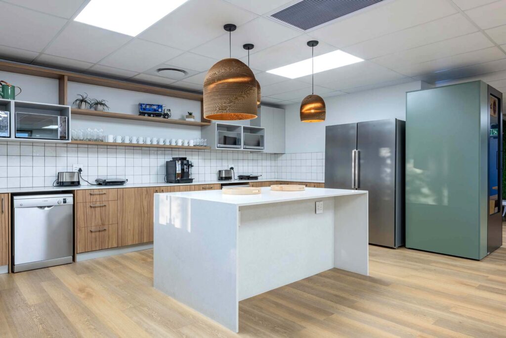 Cape Town office canteen with modern kitchen furniture, open shelving, custom counter and contemporary lighting, showcasing commercial FF&E sourcing.