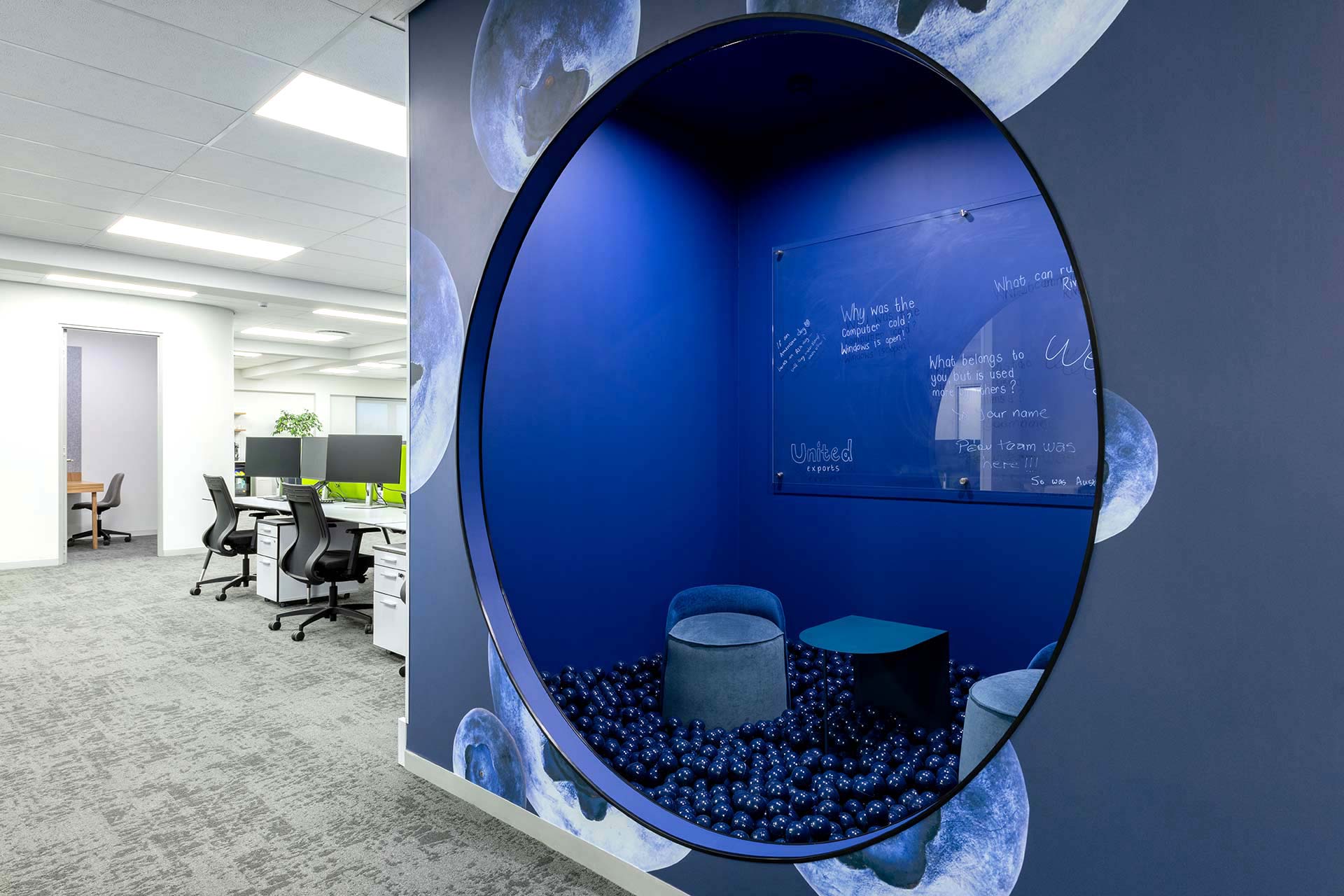United Exports Paarl collaborative pod with ottomans, small tables, ergonomic chairs and desks for flexible workplace use and brainstorming.