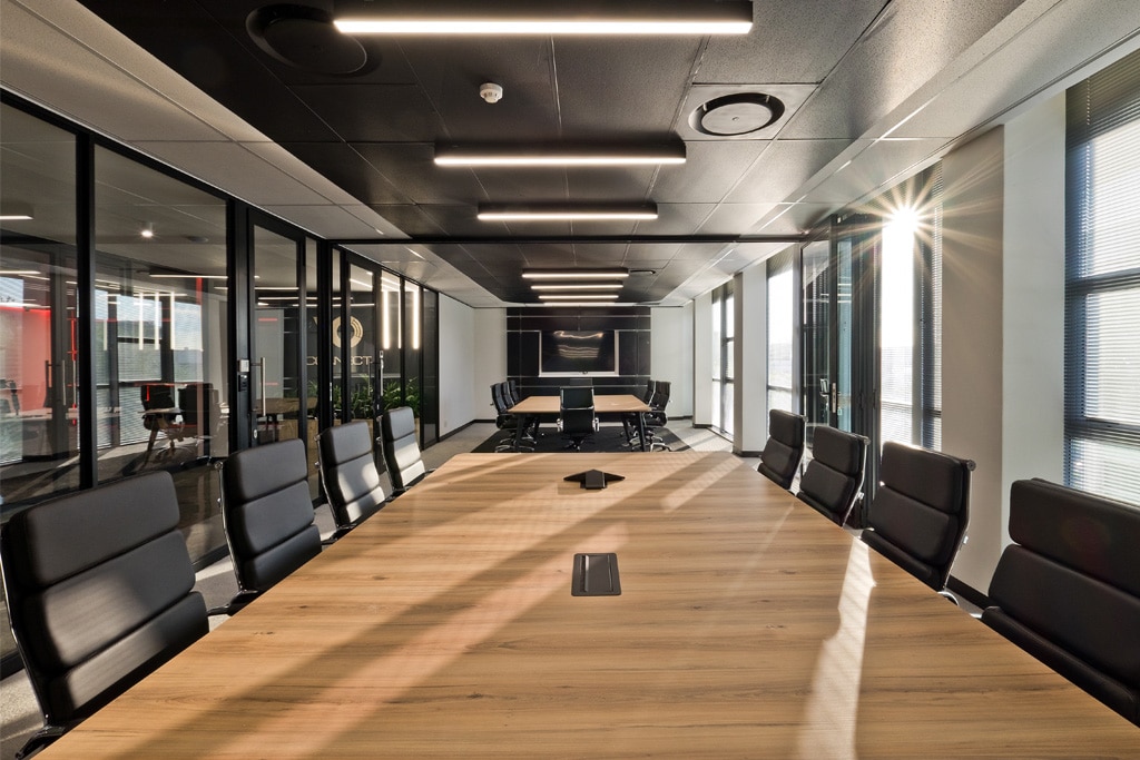 VO Connect office with ergonomic and high-back executive chairs, featuring large-scale boardroom furniture for corporate workplaces