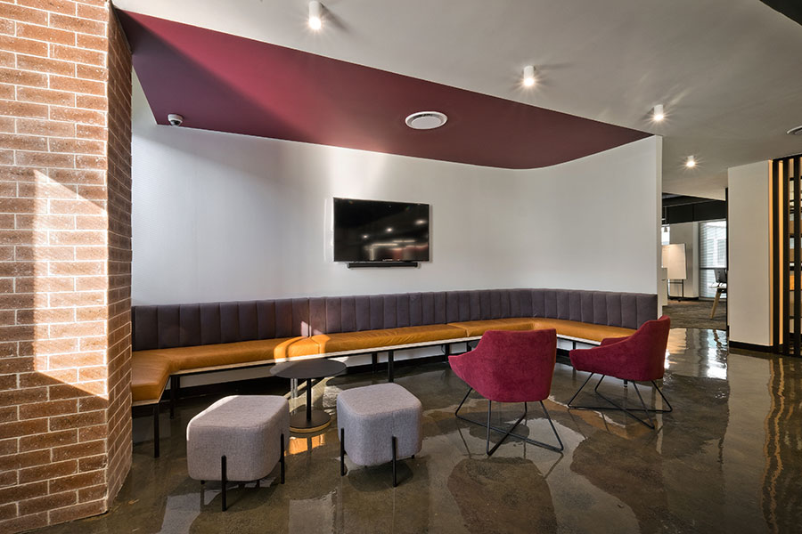 VO Connect custom office seating with branded bench, coffee tables, ottomans and modern armchairs for flexible breakout areas