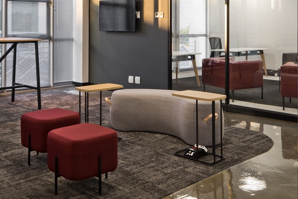 VO Connect modern office with contemporary ottomans and side tables, showcasing streamlined furniture supply chain solutions