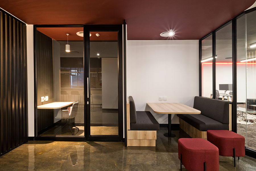 VO Connect office with modern phone booths and booth seating, featuring curated furniture aligned with the brand identity
