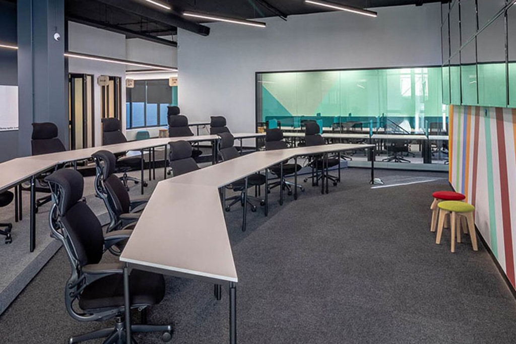 Wonderlabz Cape Town training room with custom desks and ergonomic office chairs, showcasing corporate furniture procurement