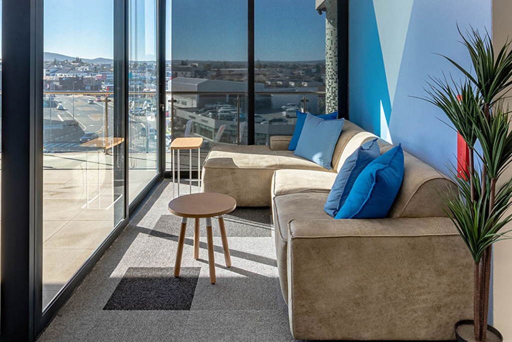 Wonderlabz Cape Town office with contemporary couches, stools and planters, showcasing flexible workplace furniture solutions