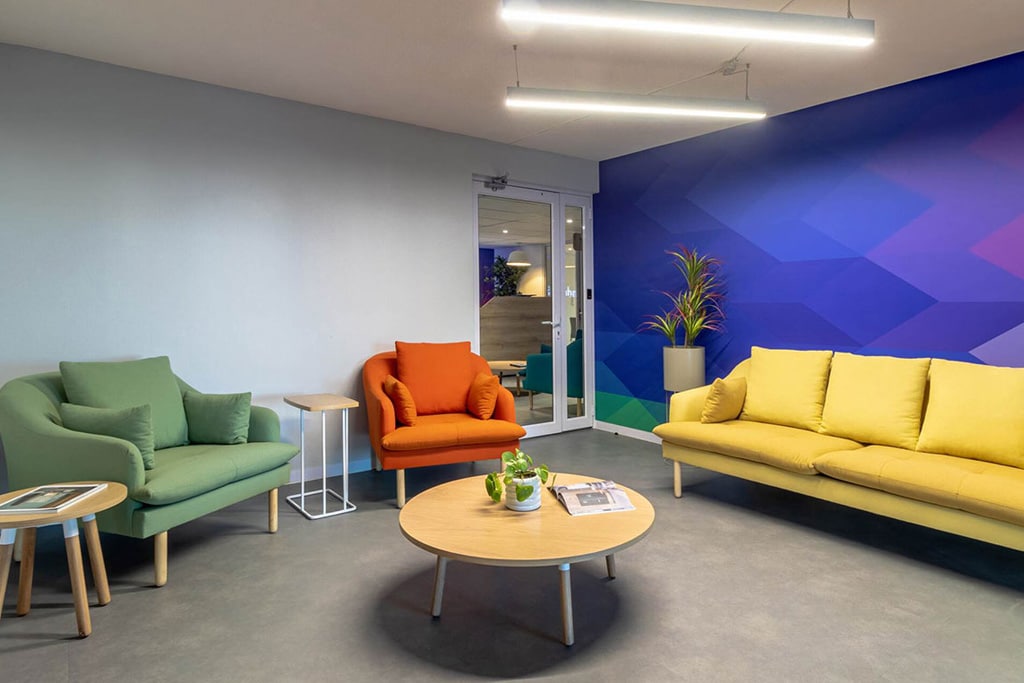 Wonderlabz Cape Town software research breakout area with colourful couches, laptop tables and coffee tables for flexible workplace use