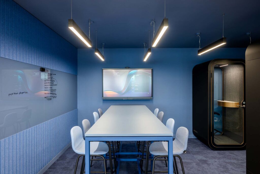 British Airways Euroflyer London office with acoustic pods, modern bar stools and high meeting tables, showcasing commercial furniture solutions.