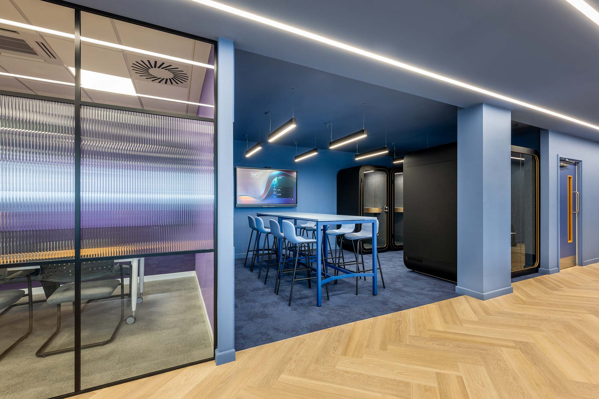 British Airways Euroflyer London office with modern furniture, acoustic pods, bar stools and light blue custom upholstery.